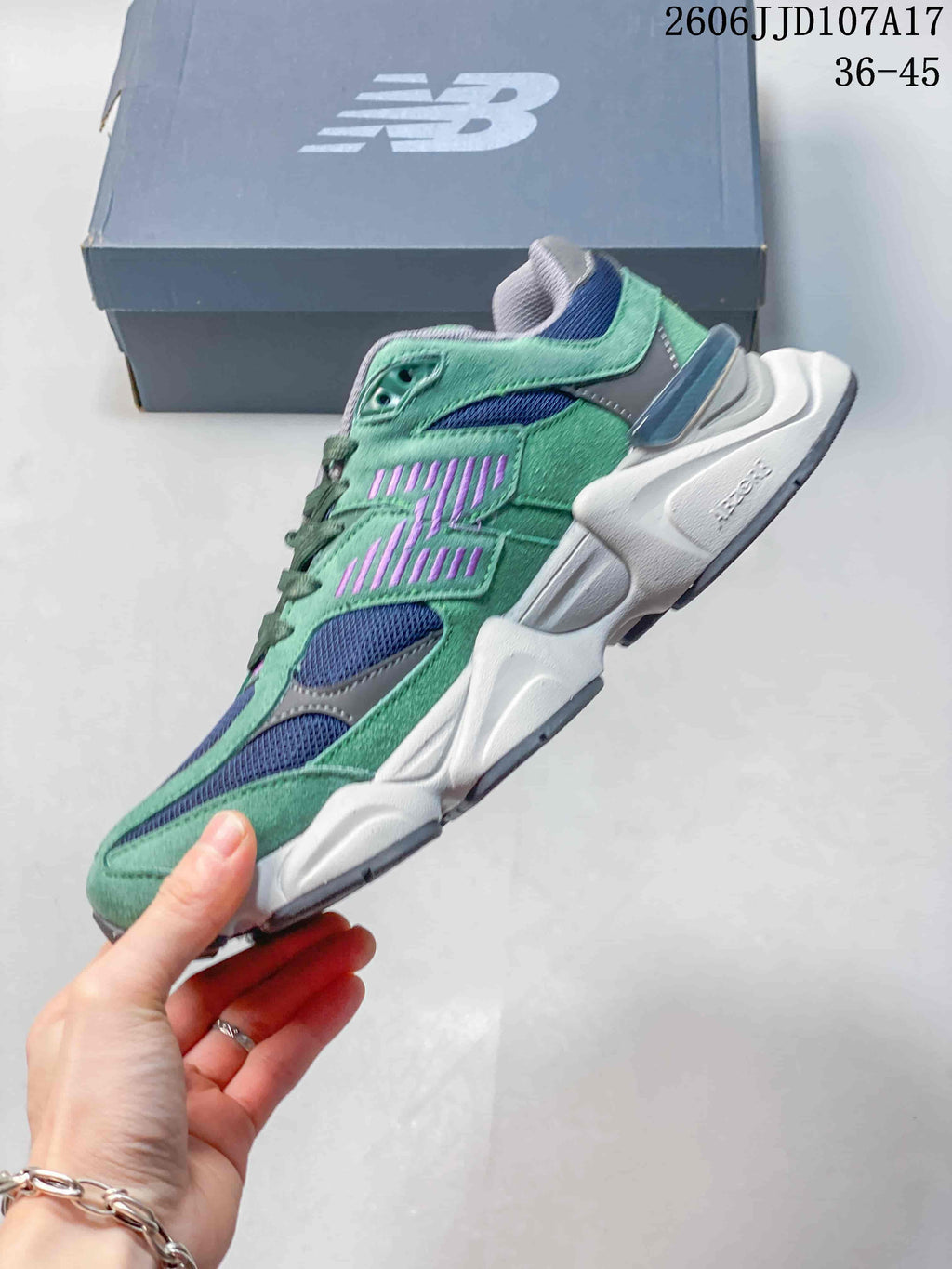 Side profile of the green New Balance U9060 with navy mesh panels and purple accents