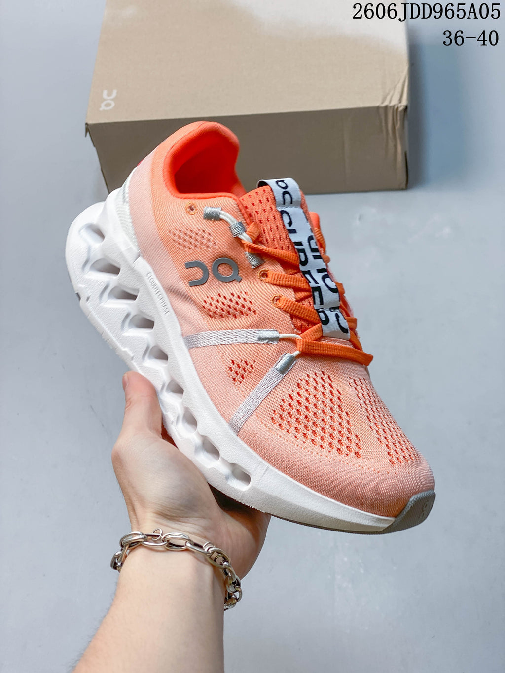 Coral On Cloudsurfer Trail shoe with a white sculpted sole