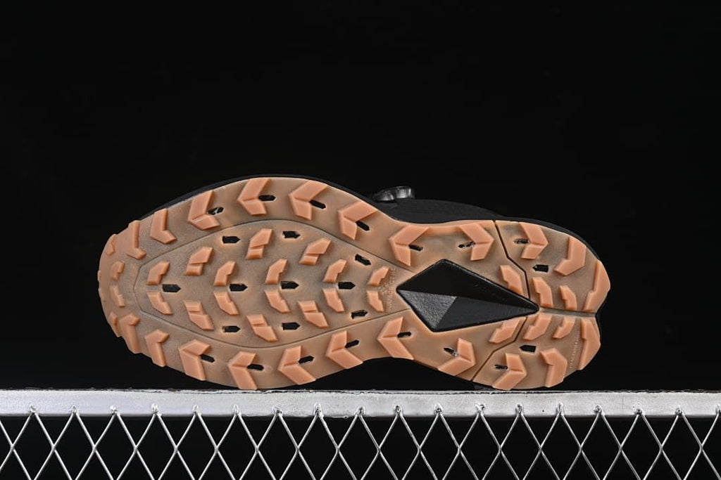 Underside view showing the tan-toned lugged outsole and central black insert.