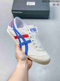 White slip-on sneaker with blue and red side stripes and a striped heel panel