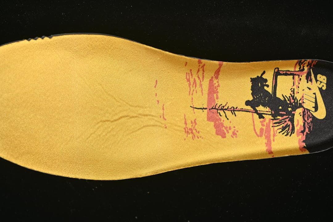 Printed yellow insole with a landscape illustration.