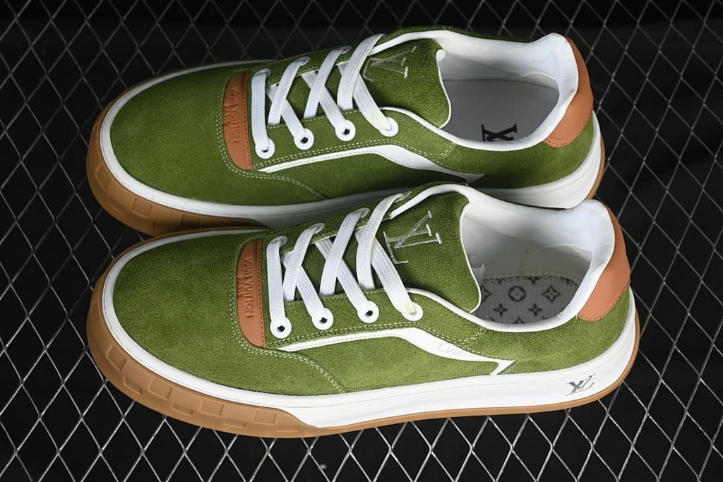 Pair of green and white low-top sneakers viewed from above