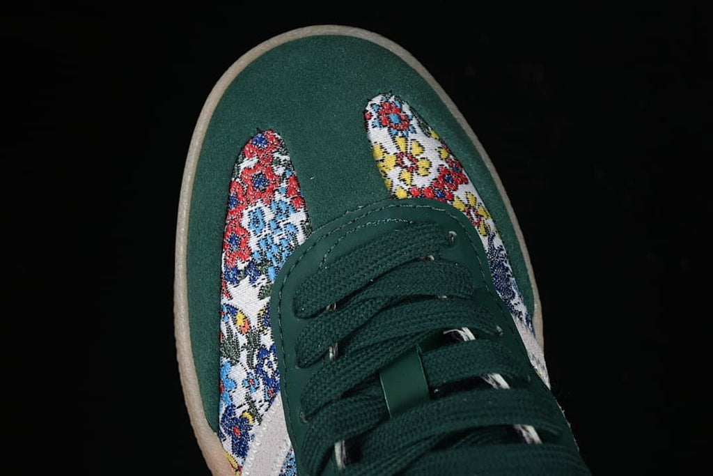 Top view of the green toe, laces, and floral-patterned panels.