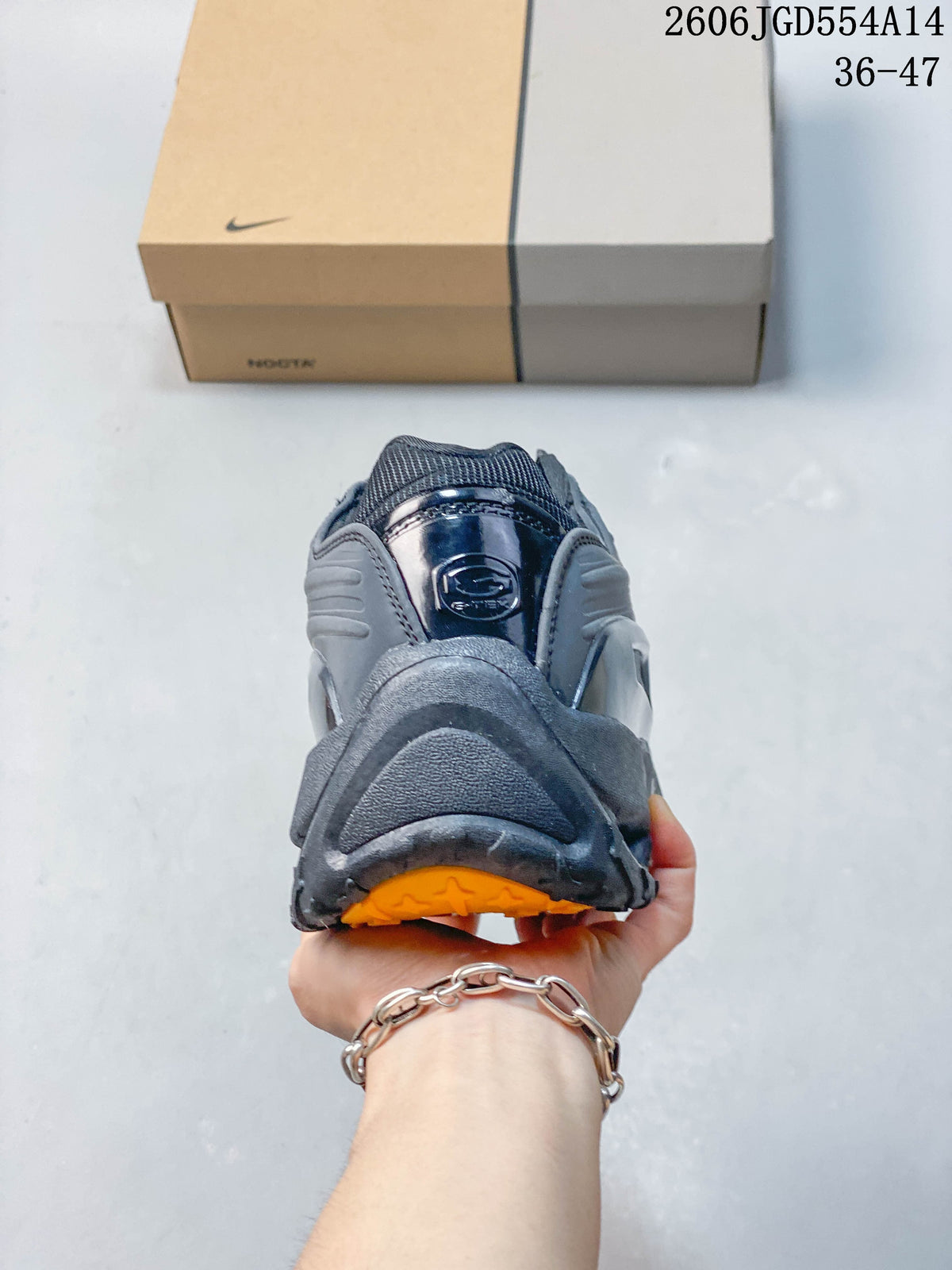 Rear view of a dark gray Nike NOCTA Hot Step 2 sneaker