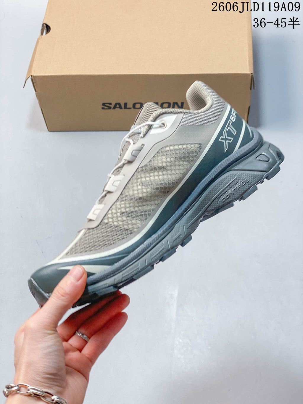 Side view of the grey Salomon XT-6 FT shoe with its mesh-look upper and blue-green accents.