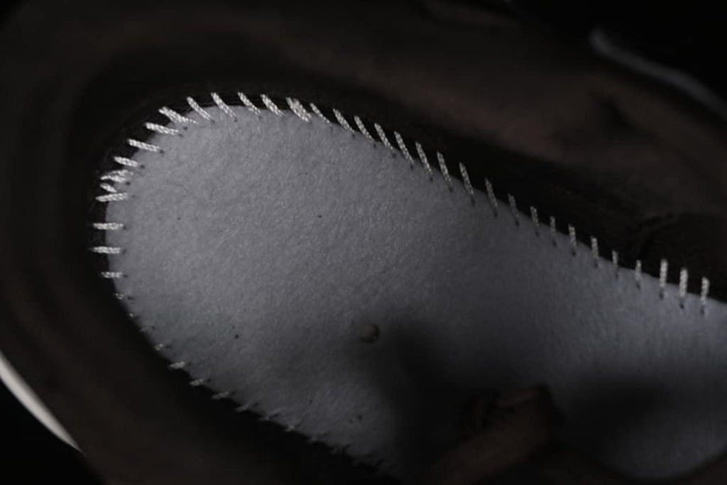 Close-up of stitching on the shoe's interior footbed