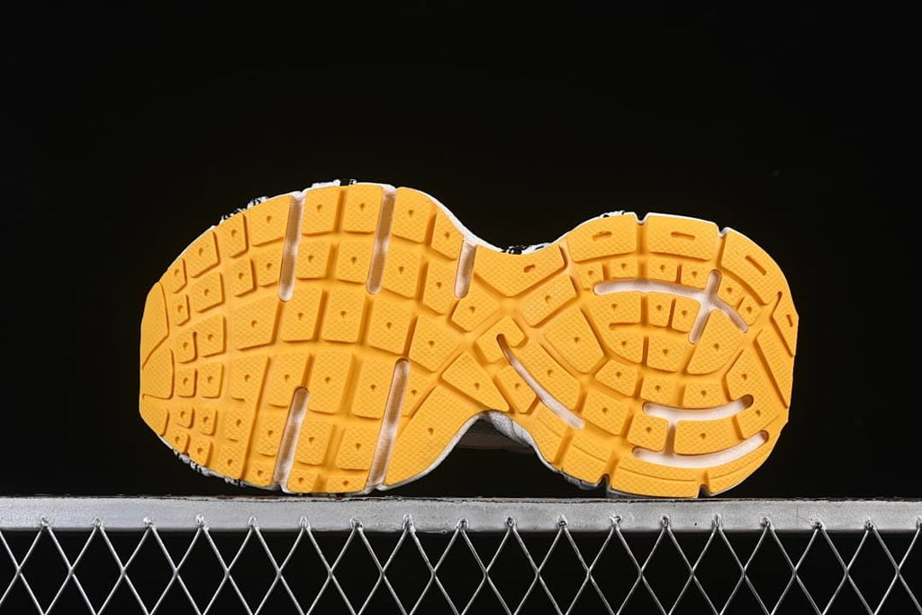 Underside view showing the orange tread pattern