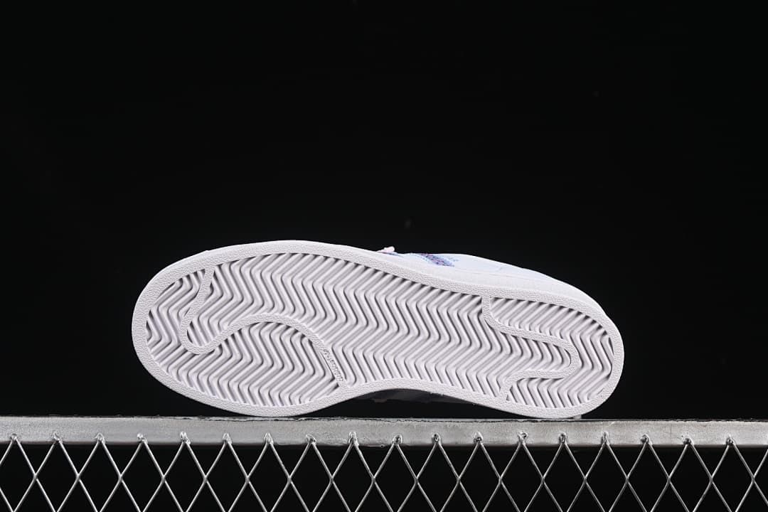 Underside view of the sneaker outsole with a herringbone-style tread pattern