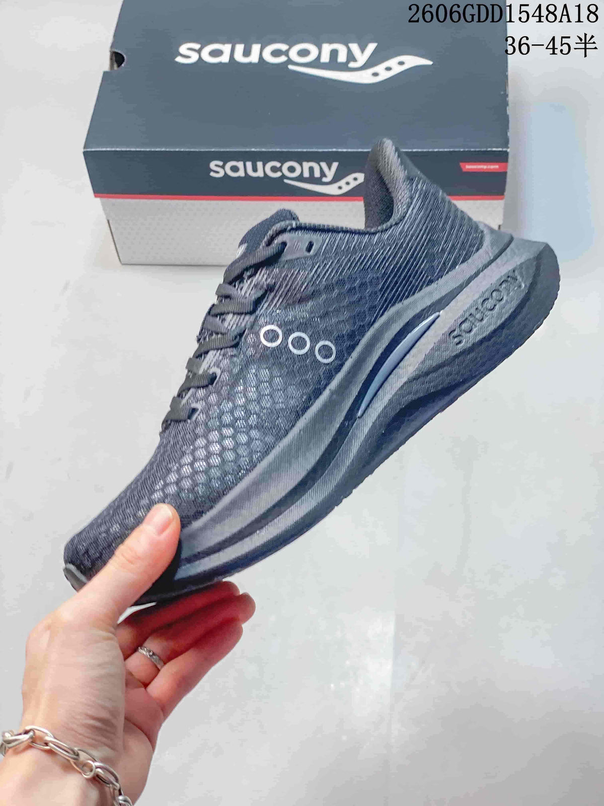 Side view of the charcoal-gray Saucony running shoe with prominent logo and sculpted sole