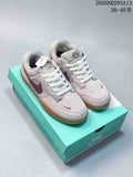 Pair of pale pink and grey Nike SB Force 58 low-top shoes with burgundy accents and gum-colored soles