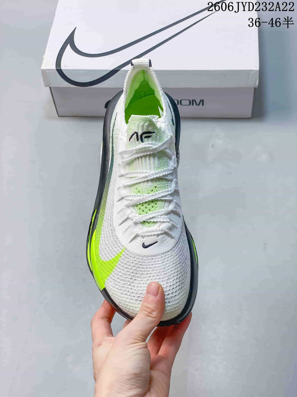 Top view of the Nike running shoe with white laces and green details