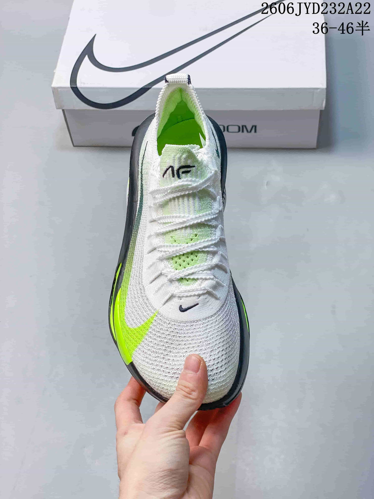 Top view of the Nike running shoe with white laces and green details
