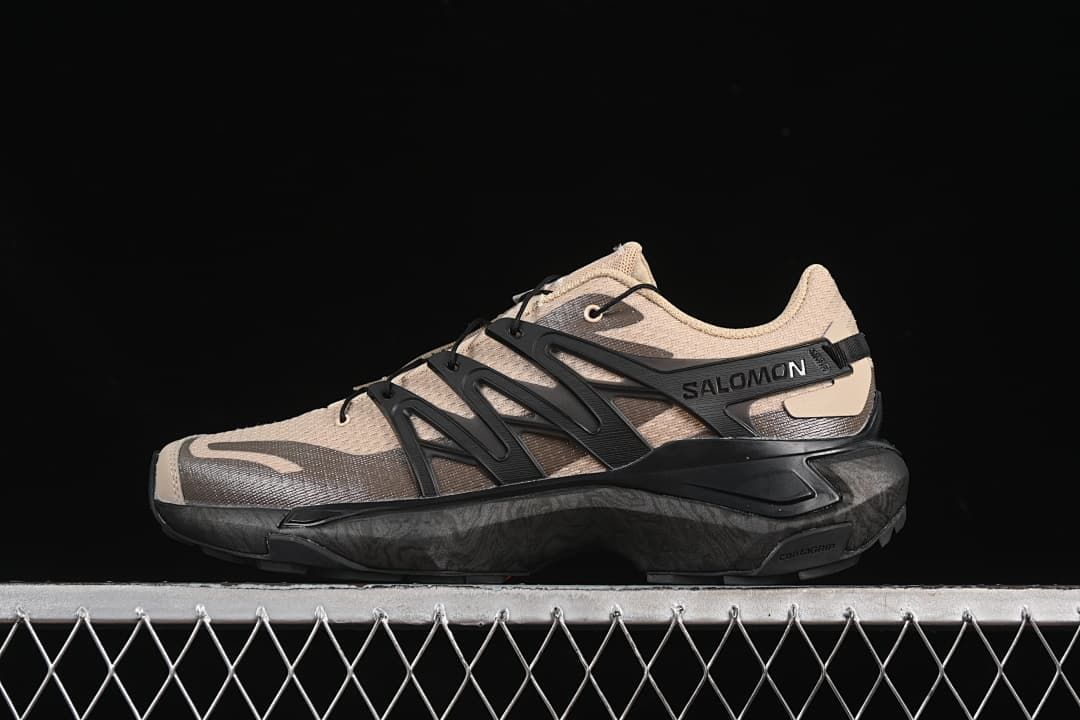Side view of sand and charcoal Salomon XT Pu.re Advanced shoe with black side supports.