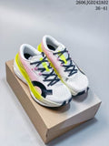 Pair of On Cloudboom Max sneakers in white, pink, neon yellow, and black, shown on a shoebox; size and product code text are visible above the shoes.