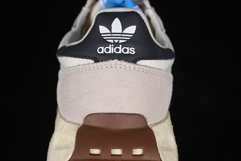 Rear view showing the adidas Trefoil heel detail and gum-colored heel outsole.