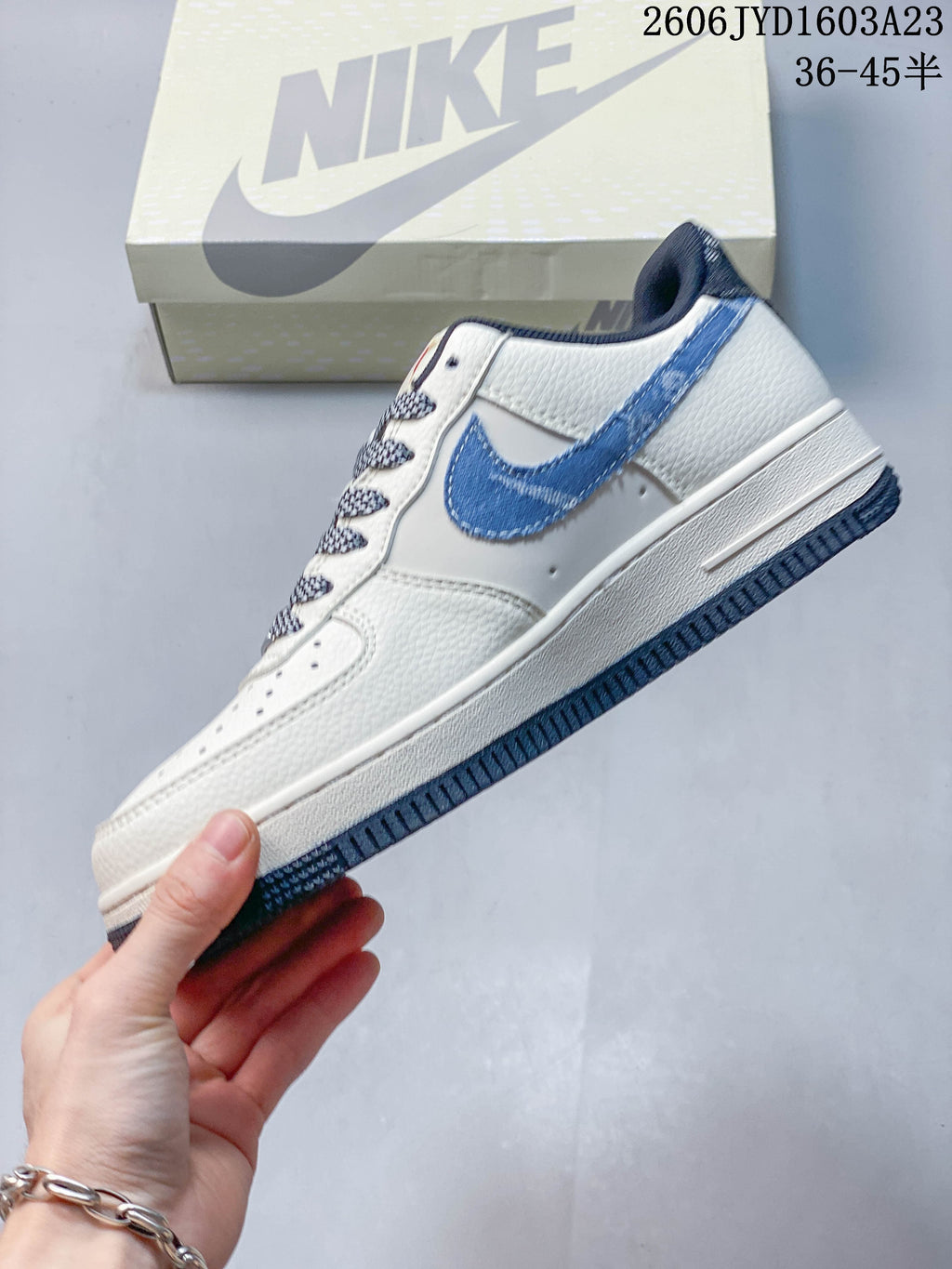 Side view of the off-white low-top sneaker with blue Swoosh overlay and navy outsole