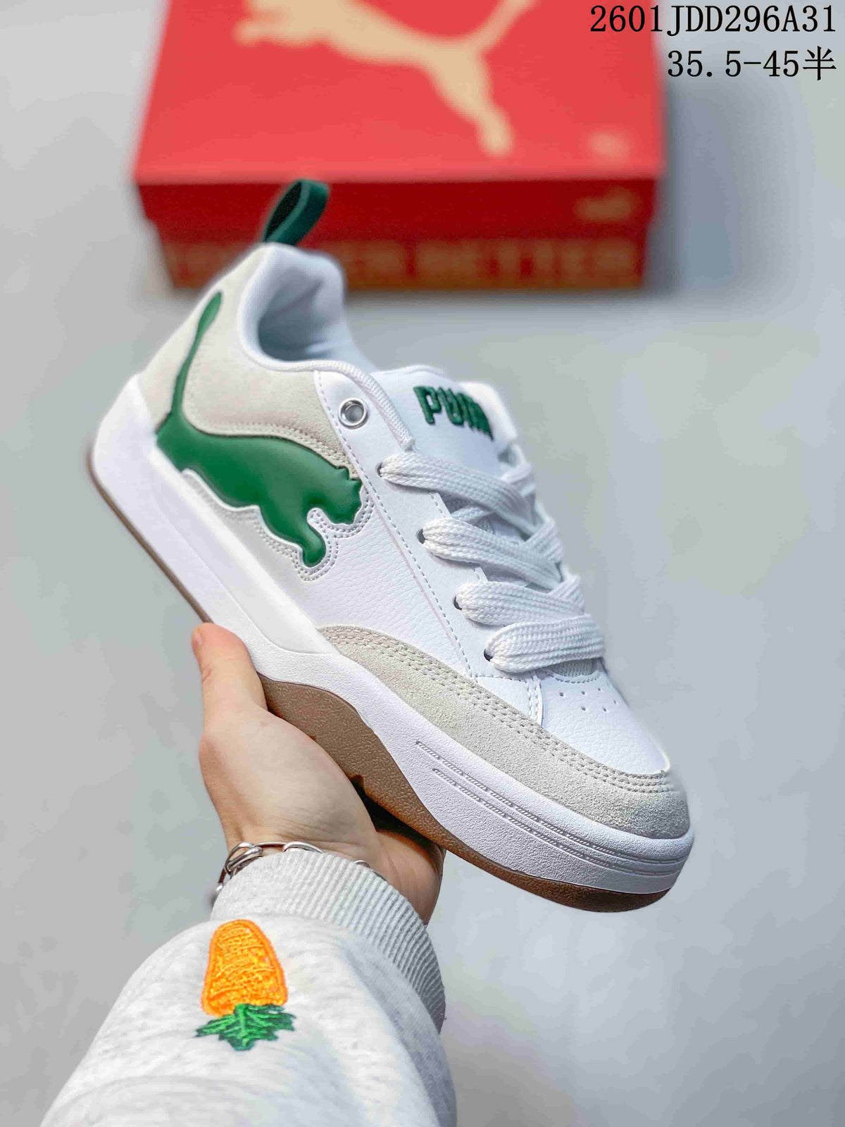 Angled side view of the white and green PUMA 180 sneaker