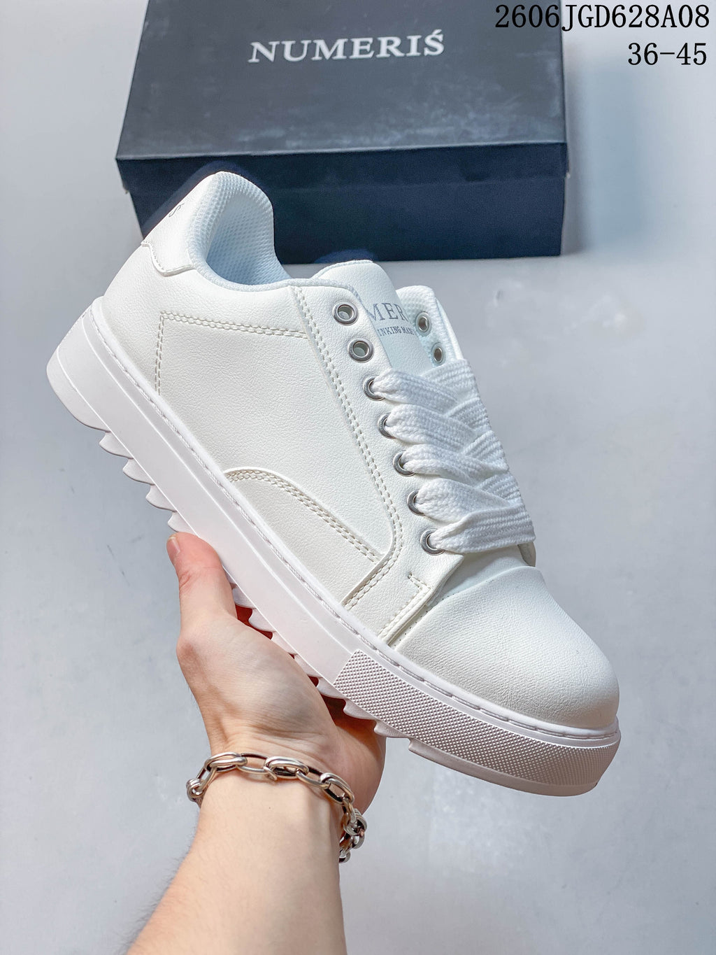 White Numeris low-top lace-up sneaker with a simple tonal design.