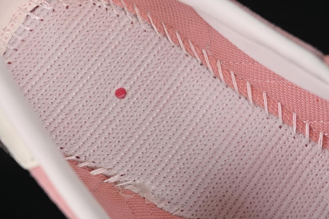 Close-up of the sneaker's pink lining and stitched interior