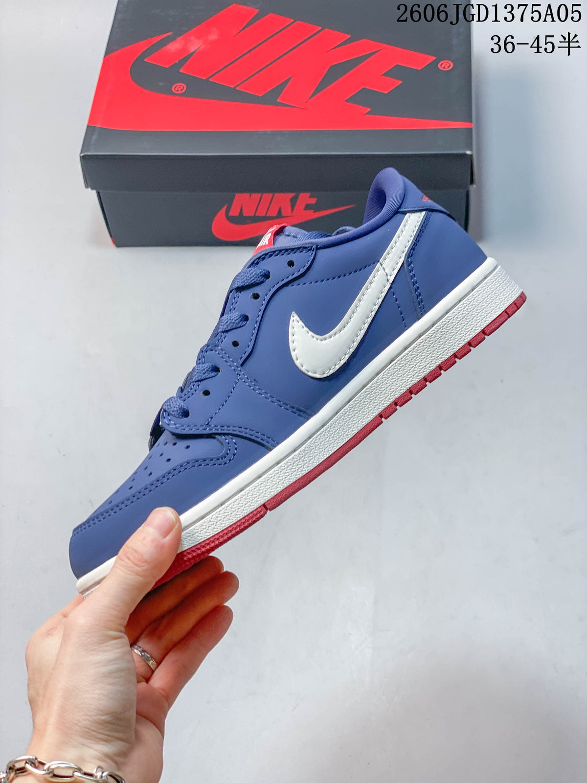 Side profile of the blue Jordan 1 Low sneaker with white Swoosh and red outsole