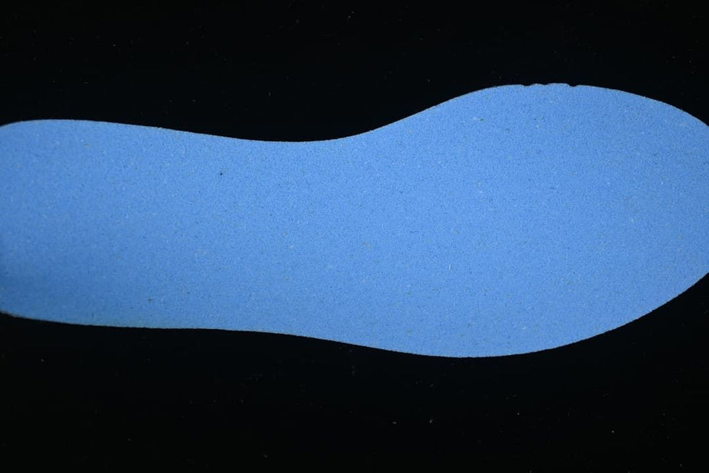Blue shoe insole shown against a dark background