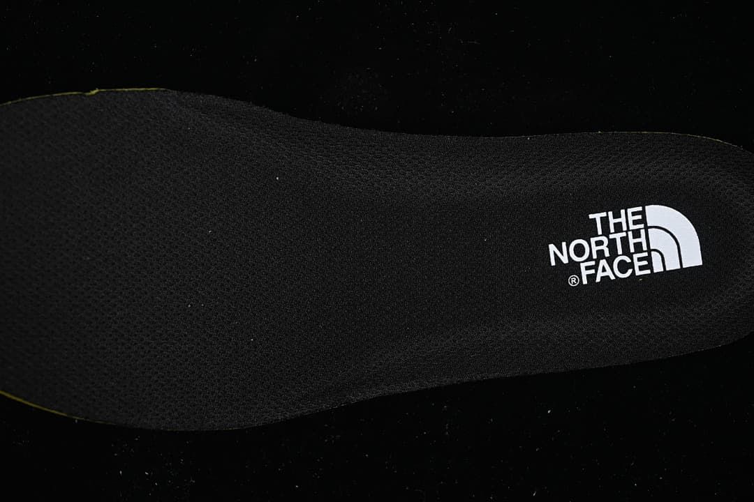 Close-up of a black shoe insole with The North Face logo.