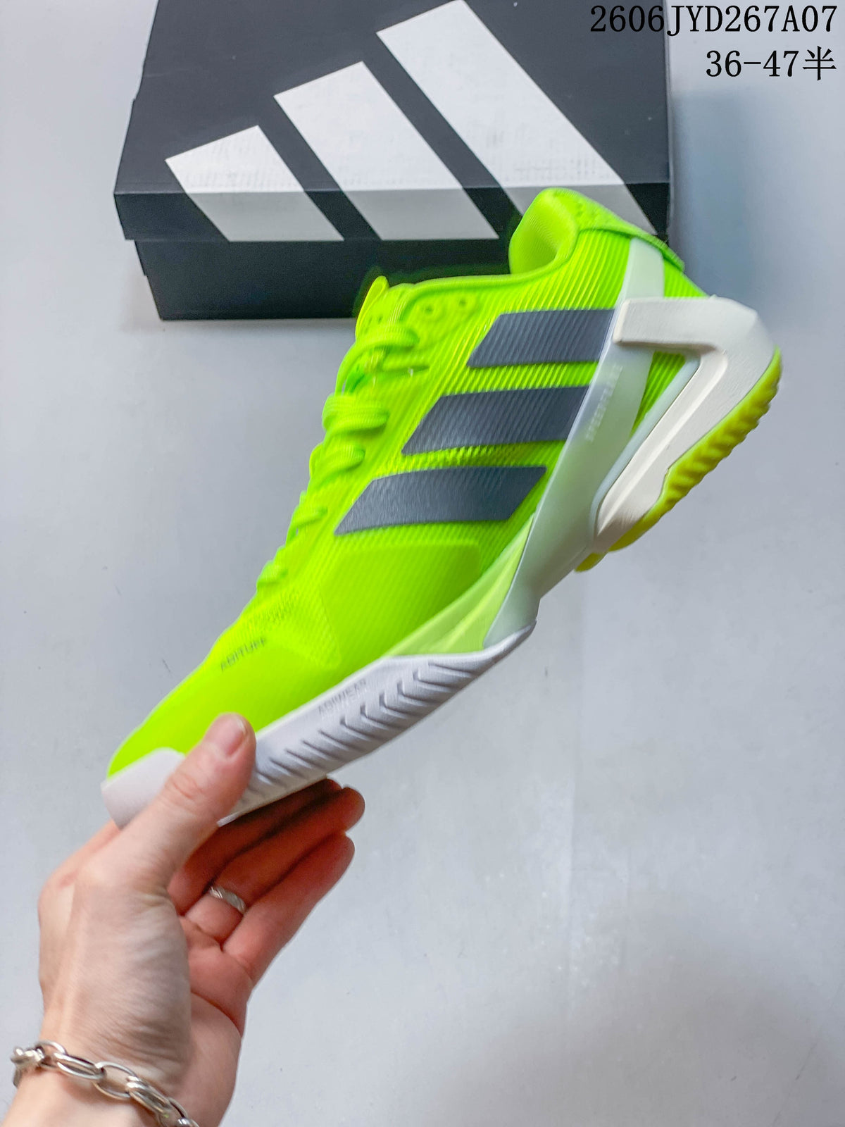 Side view of the bright yellow low-cut tennis shoe with gray stripes.