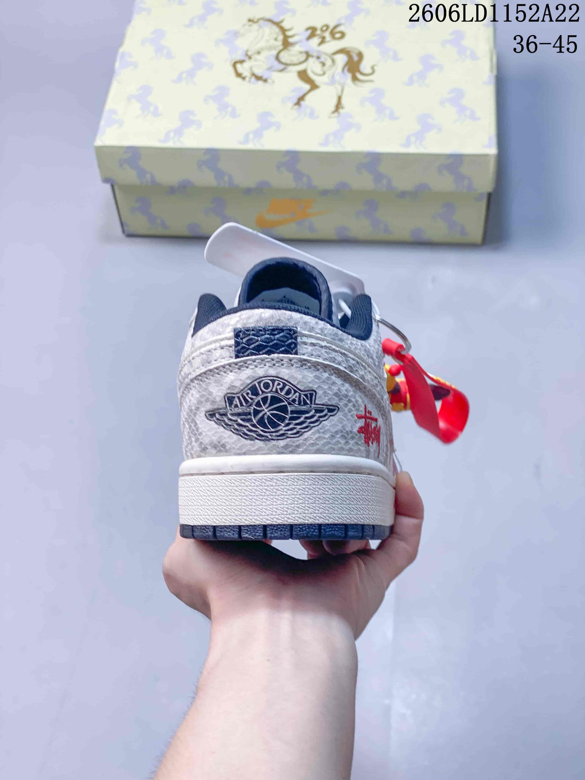 Rear view showing the heel emblem and patterned upper of a Jordan Air Jordan 1 Low sneaker.