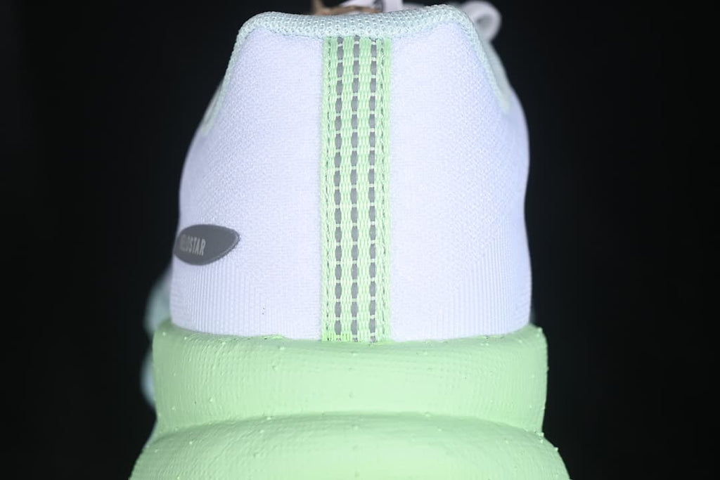 Rear view of the shoe with lime midsole and heel details