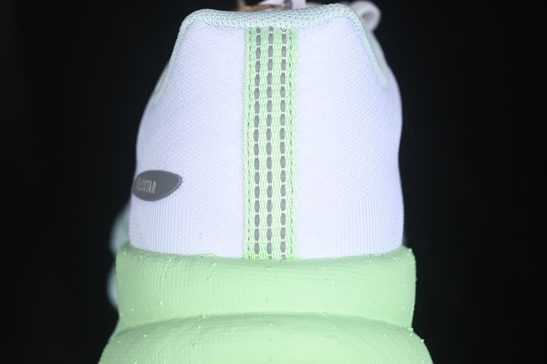 Rear view of the shoe with lime midsole and heel details