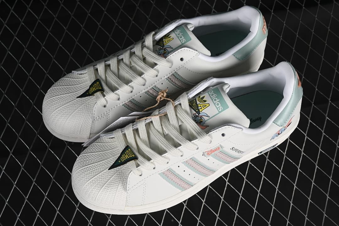 Pair of white Dumbo-themed adidas Superstar sneakers viewed from above