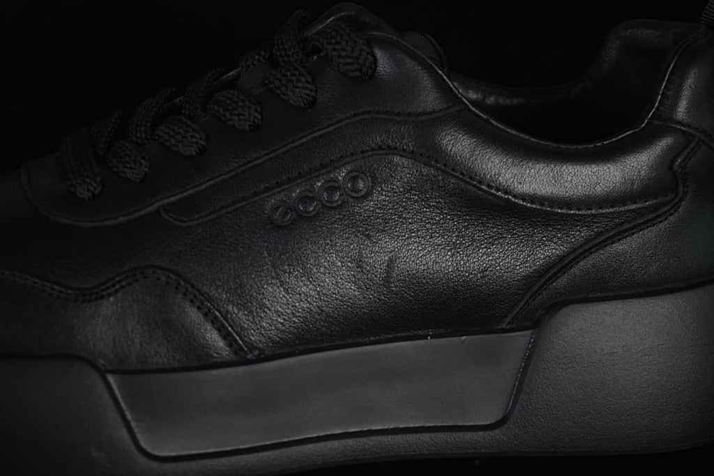 Close-up of the tonal side logo, stitched panels, and sole
