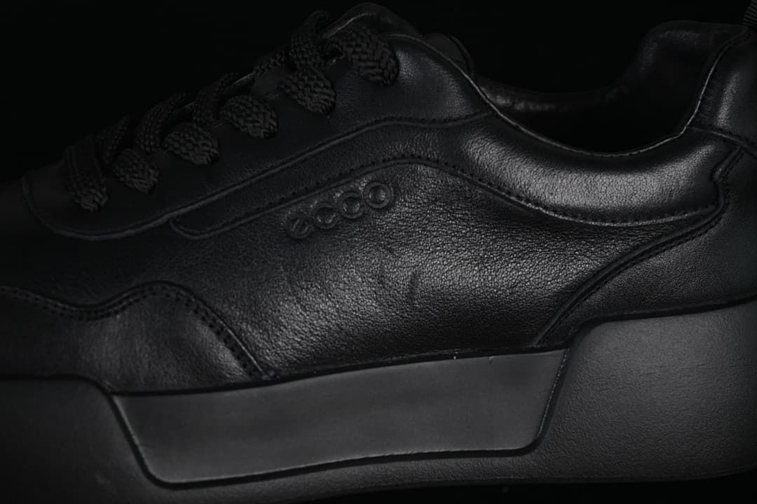 Close-up of the tonal side logo, stitched panels, and sole