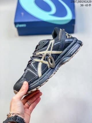 Side view highlighting the gold-toned ASICS side stripes, layered upper panels, and raised outsole.