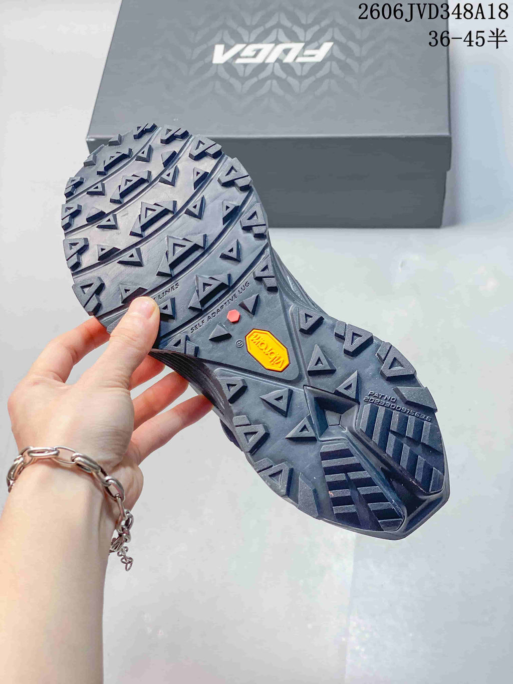 Close view of the lugged outsole with a Vibram logo.