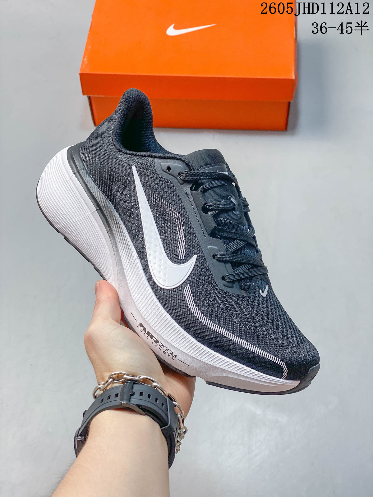 Side view of the dark gray Nike Air Zoom Pegasus 42 with white swoosh and midsole