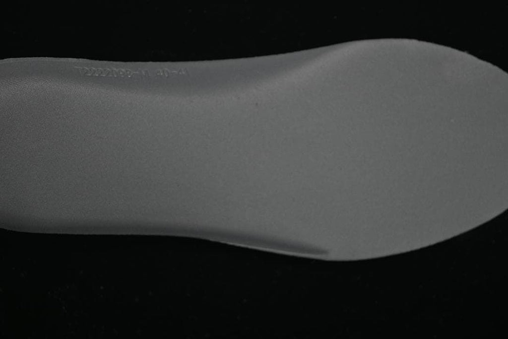 Close-up of the sneaker insole with faint embossed text