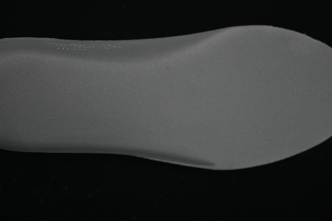Close-up of the sneaker insole with faint embossed text