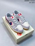 Pair of white and light grey low-top sneakers with blue and red Swoosh accents on a box