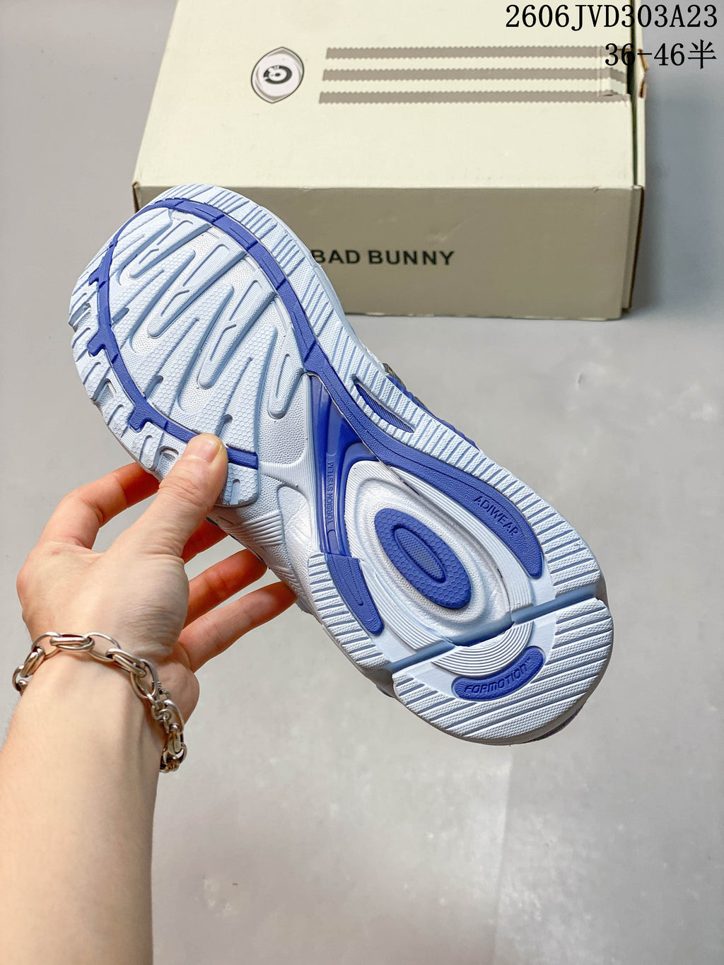 Underside of the sneaker showing a patterned white and blue outsole