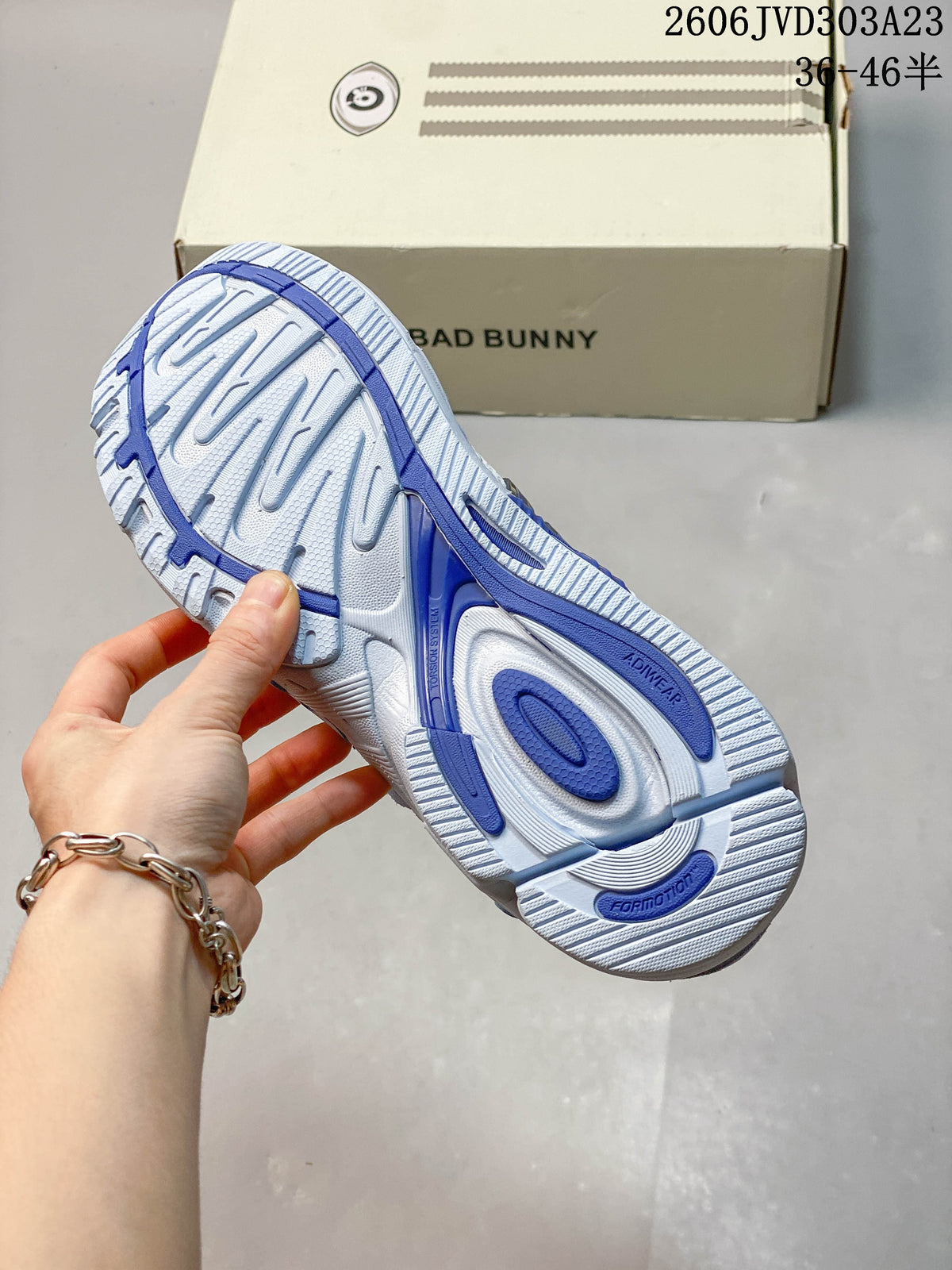 Underside of the sneaker showing a patterned white and blue outsole
