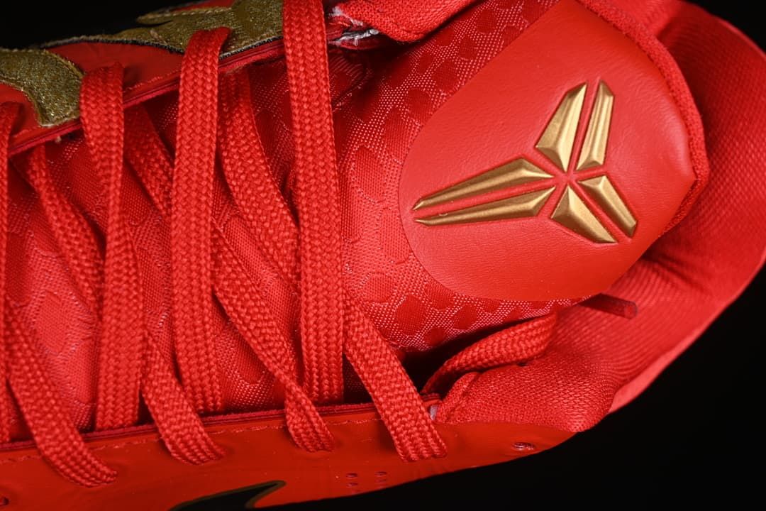 Close-up of red laces and gold basketball-style tongue emblem