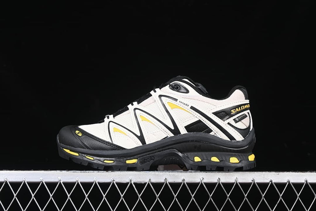 Side view of the Salomon XT-Quest GTX shoe in off-white, black, and yellow.