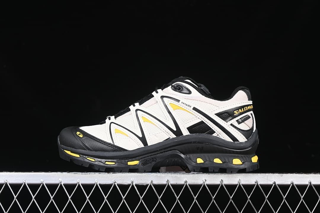 Side view of the Salomon XT-Quest GTX shoe in off-white, black, and yellow.