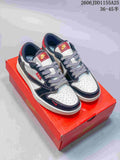 Pair of white and navy low-top Jordan sneakers with red accents on a red shoebox