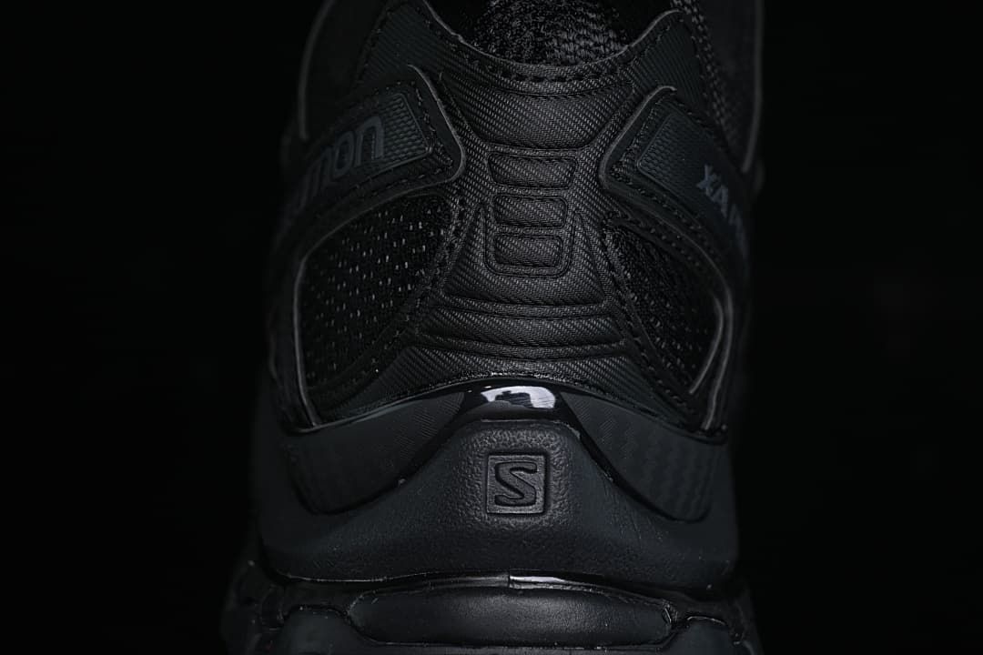 Rear view of the black shoe showing heel details and Salomon branding