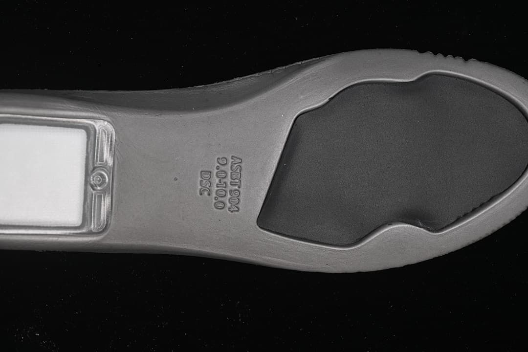 Close-up of the sneaker outsole with molded markings.