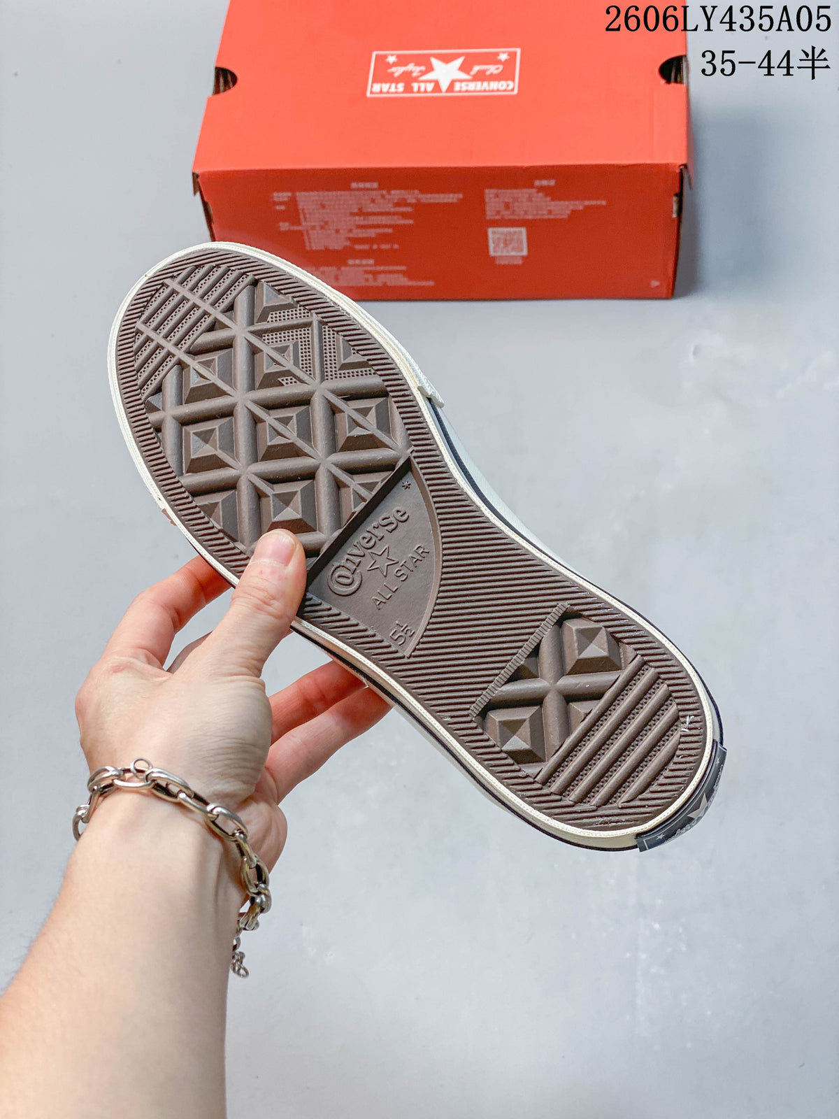 Close-up of the patterned rubber outsole of a blue high-top sneaker