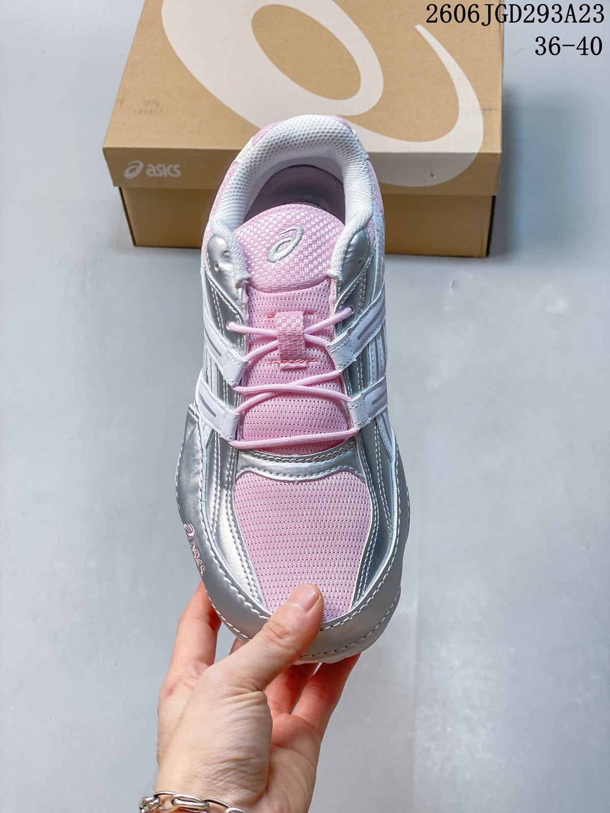 Top view of the sneaker showing pink panels, laces, and silver overlays.