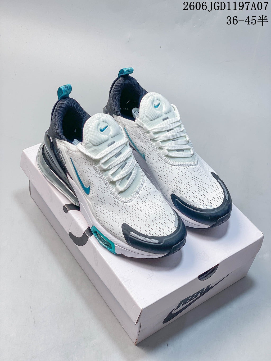 Nike Air Max Pulse shoes in white, teal, and navy shown from above on a shoebox